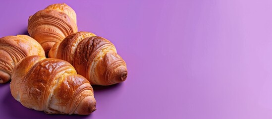 Four cream filled rolls on a purple backdrop with space for adding text in the image. Copy space image. Place for adding text and design