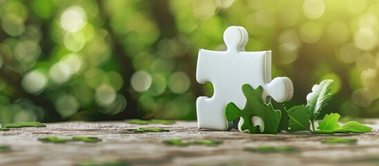 A symbolic representation of teamwork on a white puzzle piece against a lovely green backdrop conveying a business and team building concept with room for text or visuals. Copy space image