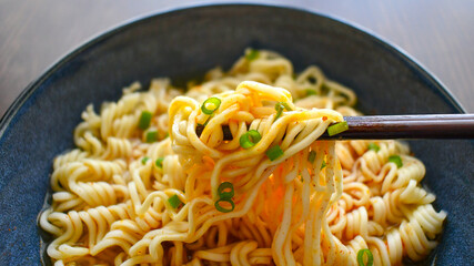 Instant noodles with chopsticks in a bowl. 