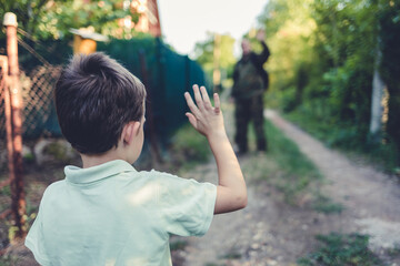 The dad is leaving for overseas assignment. The boy standing in front of the gate and sending his father off on an overseas assignment.