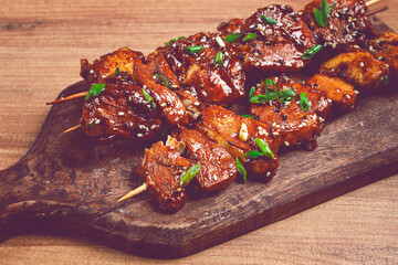 yakitori chicken kebab, on skewers, with green onions and sesame seeds, top view, without people,
