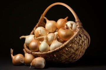 Still life capture of a wicker basket spilling fresh onions onto a dark surface