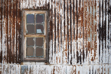 weathered corrugated iron wall with window