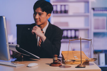 Judge gavel with Justice lawyers having team meeting at law firm background. Concepts of Law and...