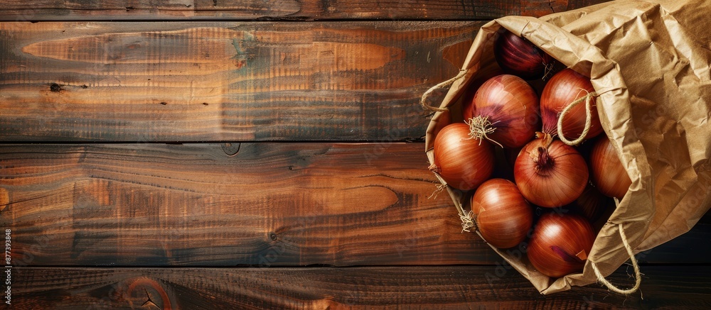 Poster organic onions in a paper bag on a wooden background with selective focus and top view for a bio pro
