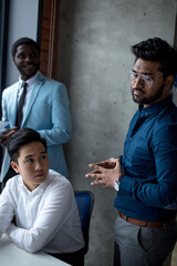 Male corporate team show activity at teambuilding with multiethnic colleagues, mixed race workers brainstorm at office education briefing