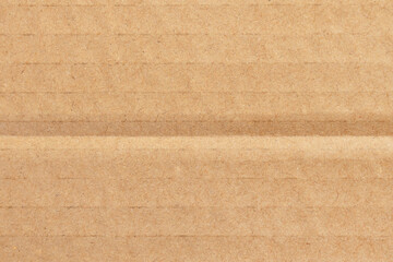 Corrugated cardboard box brown surface with fold lines. Recycled paper texture background