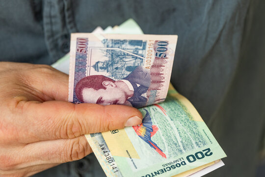 Honduras money, man counting lempiras, banknotes of Honduras, financial business concept, means of payment in Latin America