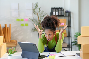 Exhausted young entrepreneur tackling e-commerce and shipping challenges while running online business from home office, displaying signs of burnout