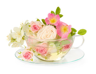 Aromatic herbal tea in glass cup with different flowers isolated on white