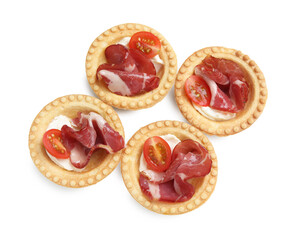 Delicious canapes with jamon, cream cheese and cherry tomatoes isolated on white, top view