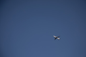 A beautiful plane flies in the sky. White plane. Blue sky.