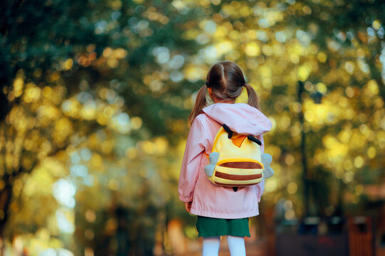 Cute Little Girl Going Back to School. Child wearing a backpack ready for the first day of kindergarten 
