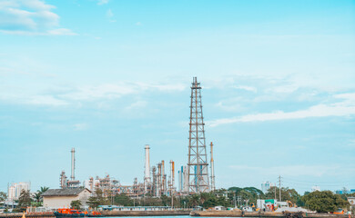 Large Industrial Plant by Waterfront under Blue Sky | Energy refinery and industrial structures....