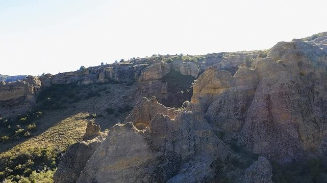 Aerial-First person (FVP) view flying close over rugged peaks of geological conglomerate material