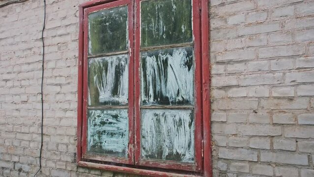 Neglected Abandoned Building Window Painted From Inside with White Painted