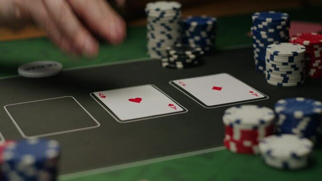 Game of poker in casino, taking place with poker chips and cards on a green table, gambling place, roulette jack pot. 