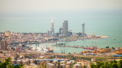 Aerial view of Batumi modern skyline with distinctive skyscrapers, busy port, and Ferris wheel by...