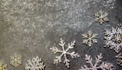 on a metallic rough background lie snowflakes winter time texture and snow