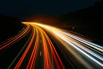 Long exposure shot of vehicle headlights and taillights on a highway, showcasing the movement and dynamism of road transport at night 