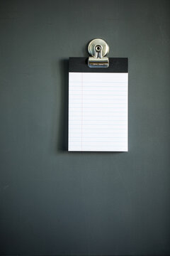 Lined note paper on dark gray magnet board