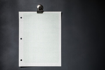 Green graph paper on dark gray magnet board
