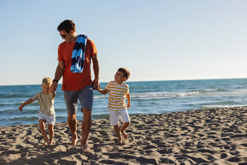 Father and Sons Strolling on the Beach