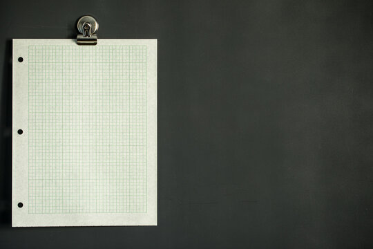 Green graph paper on dark gray magnet board