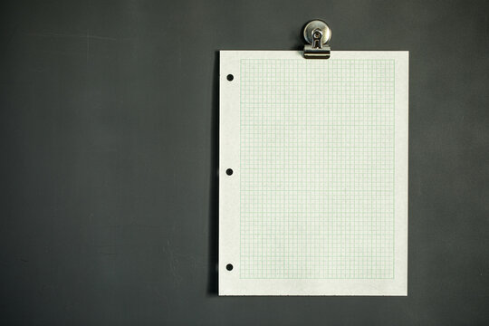 Green graph paper on dark gray magnet board