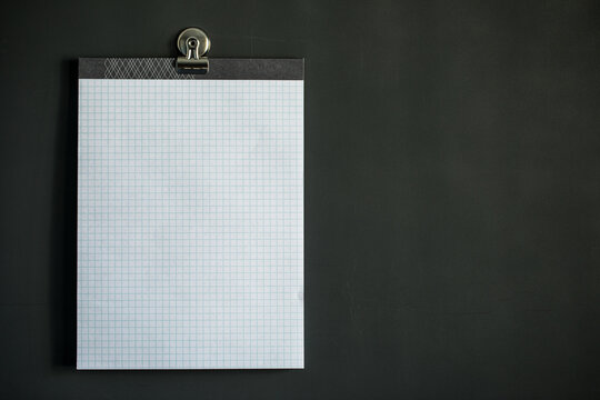 White graph paper on dark gray magnet board