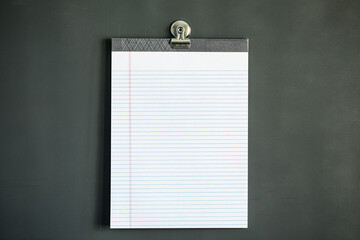 Lined note paper on dark gray magnet board