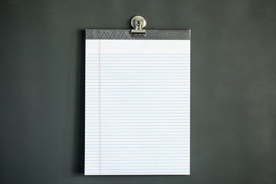 Lined note paper on dark gray magnet board