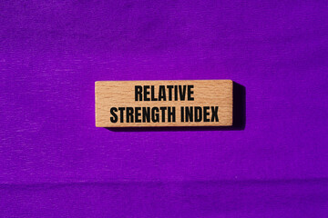Relative strength index message written on wooden blocks with purple background. Conceptual relative strength index symbol. Copy space.