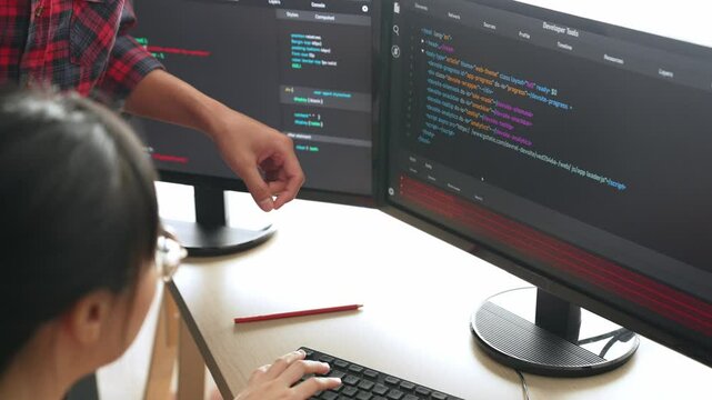 Slow motion back end or software developer manager supervising his team on new application program development on debugging and solving complex code algorithms on monitor. Burgeoning