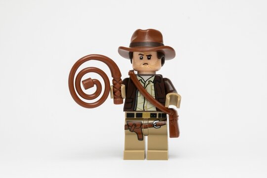 Indiana Jones Lego figure against a plain white background holding a whip