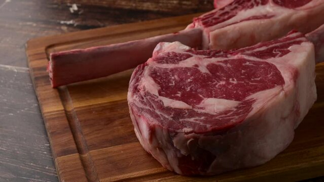 fresh tomahawk beef steak on cutting board