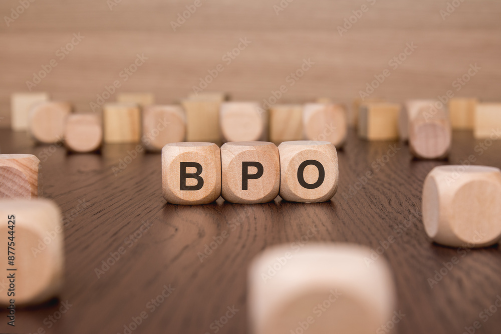 Poster bpo text 'business process outsourcing' wooden cube blocks on table background. business process out
