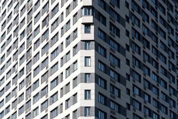 Sun and shadow on the facade of a modern building, background.