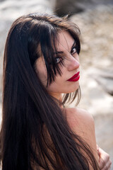 Fototapeta premium Brunette model with long hair posing on beach
