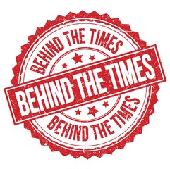 BEHIND THE TIMES text on red round stamp sign