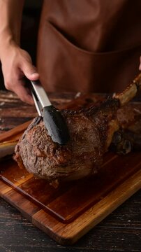 grilled tomahawk steak on cutting board