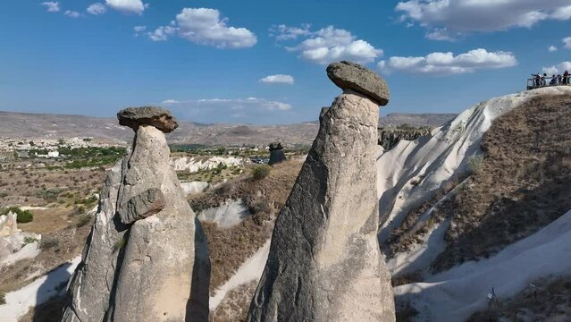 Cappadocia most popular view in sunrise. Turkey. Goreme National Park. Drone footage of red valley rocks formations called the Fairy Chimneys. Open air museum aerial shot of city and houses from caves