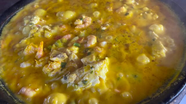 Fish moqueca with shrimp, traditional Brazilian food made in a clay pot