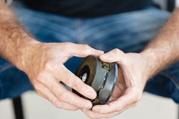 Man threading line into trimmer head of grass trimmer - step by step instructions