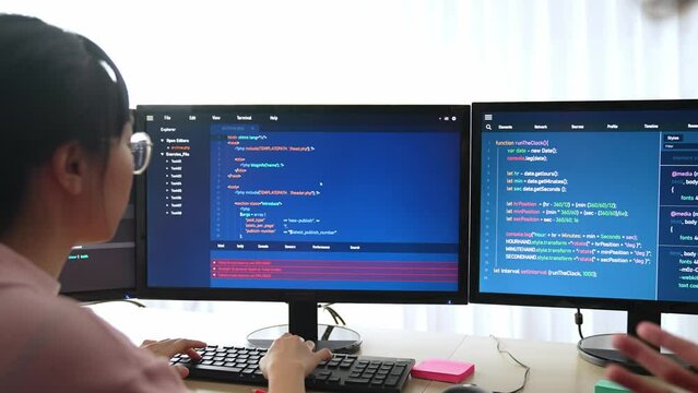 Slow motion back end software developer engineer for computer programming working together on debugging writing computing code, solving complex algorithms display on monitor in office. Burgeoning