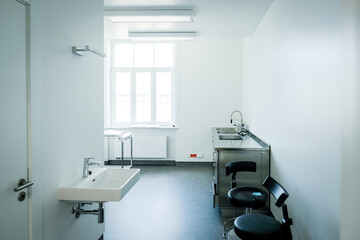 A doctor's office with a couch and a chair to examine a patient's health
