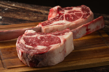 fresh tomahawk beef steak on cutting board