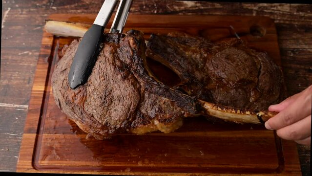 grilled tomahawk steak on cutting board