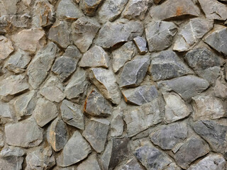 Rough textured gray stone wall with a timeless architectural feel