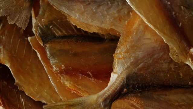Dry fish snack for beer and drinks yellowstripe scad close-up. The yellowstripe scad is commonly used as a dried fish snack in Asian countries, processed either by salting, curing or mechanical drying